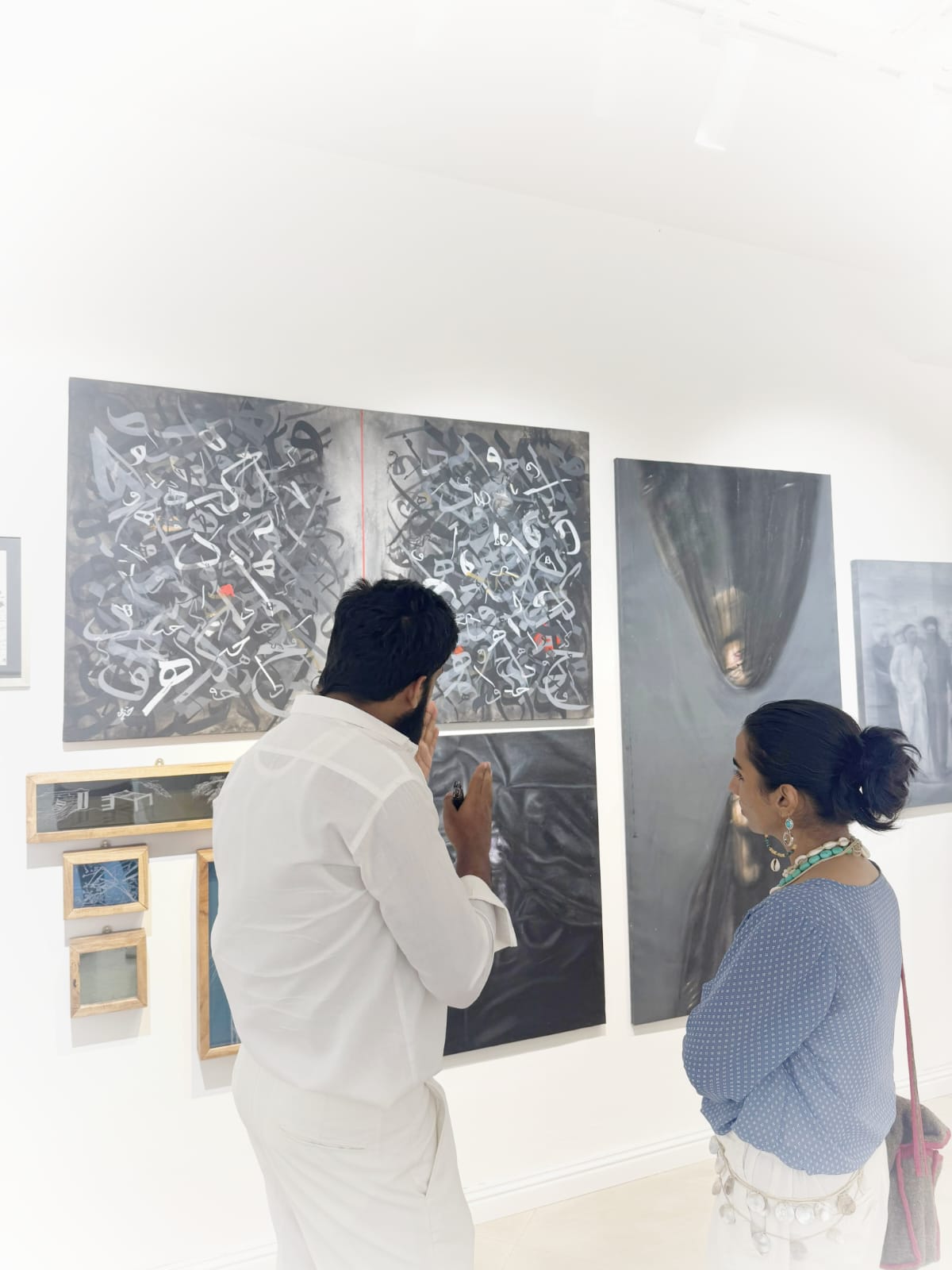 Khuzaima Ayaz discussing his work with a visitor at The Summer Show 2026